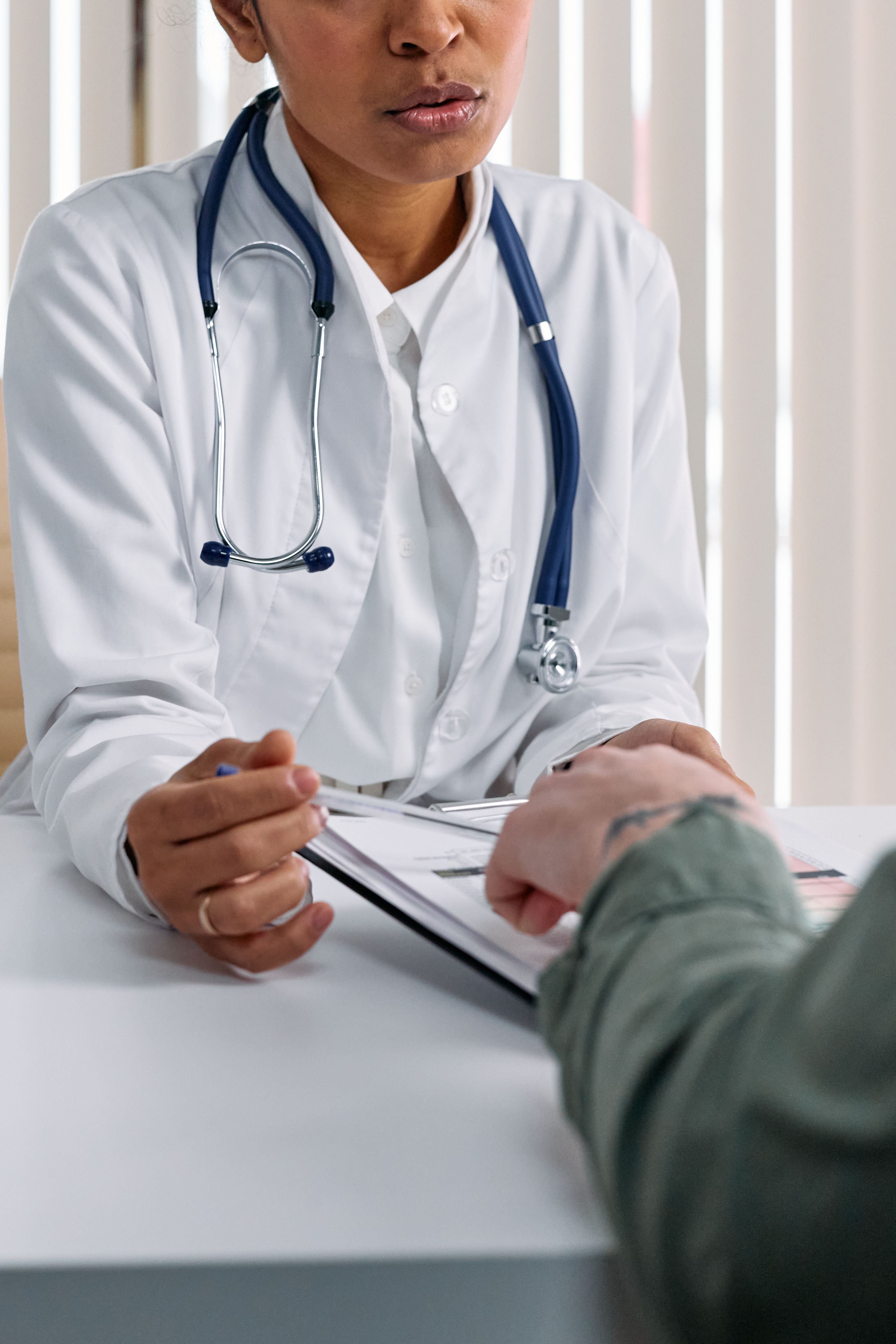 A doctor speaking with a patient during a consultation